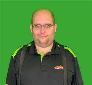 Will Canimore who is one our production technician, male employee in front of green background