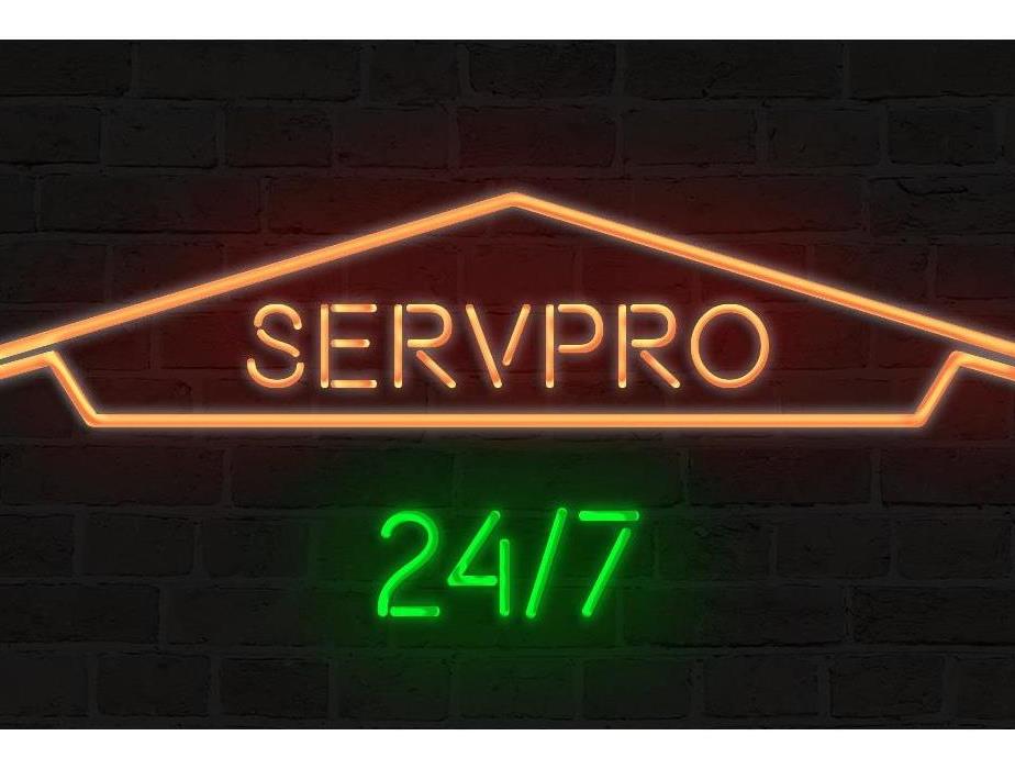 SERVPRO neon sign that states 24/7 service